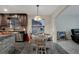 Dining area with view of kitchen featuring tile backsplash and stainless appliances at 2372 Topaz Trl, Kissimmee, FL 34743