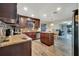 Well-lit kitchen features granite counters, an island and opens to the living room at 2372 Topaz Trl, Kissimmee, FL 34743