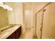 Bathroom featuring a double sink vanity with granite countertop and a glass-enclosed shower at 6078 Bimini Twist Loop, Orlando, FL 32819