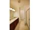 Bathroom featuring a double sink vanity with granite countertop and a glass-enclosed shower at 6078 Bimini Twist Loop, Orlando, FL 32819
