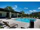 Resort-style community pool with ample seating, palm trees, and a covered lounge area at 6078 Bimini Twist Loop, Orlando, FL 32819