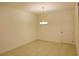 Empty dining room with tiled flooring, chandelier, and bright neutral walls offering versatile design potential at 6078 Bimini Twist Loop, Orlando, FL 32819