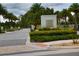 Well-maintained community entrance with a monument sign that reads 'Sand Lake Sound', surrounded by greenery at 6078 Bimini Twist Loop, Orlando, FL 32819