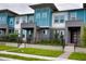 Modern townhome boasts colorful design, professional landscaping, and inviting entrance at 6078 Bimini Twist Loop, Orlando, FL 32819