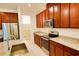Modern kitchen features stainless steel appliances, granite countertops, and ample storage space at 6078 Bimini Twist Loop, Orlando, FL 32819
