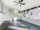 Spacious screened porch with ceiling fan and dark flooring at 666 Avenue B Sw, Winter Haven, FL 33880