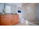 Bathroom featuring glass shower, cherry vanity, and granite countertop at 14038 Millington St, Orlando, FL 32832