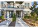 Modern townhouse with stone accents, black doors, private balconies, and manicured landscaping at 1800 Houston St, Kissimmee, FL 34743