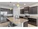 Modern kitchen featuring granite countertops and dark wood cabinets at 1869 Brockridge Rd, Kissimmee, FL 34744