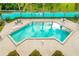 Community pool with surrounding patio furniture at 458 Hunter Cir, Kissimmee, FL 34758