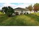 Green backyard with small patio, trees, and partial view of house at 504 Ridge View Dr, Davenport, FL 33837