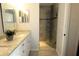 Bathroom featuring a granite vanity, framed mirror, and a glass door shower with tile surround at 504 Ridge View Dr, Davenport, FL 33837
