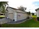 Home exterior featuring a well-maintained lawn, landscape beds, and attached two car garage at 504 Ridge View Dr, Davenport, FL 33837