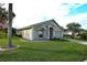 Single-story home with manicured lawn, brick driveway, and lush landscaping under a partly cloudy sky at 504 Ridge View Dr, Davenport, FL 33837