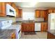 Bright kitchen featuring stainless steel appliances, granite countertops, and wooden cabinets at 504 Ridge View Dr, Davenport, FL 33837
