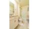 Bathroom features a vanity, toilet, shower/tub combo and tile floor with accent rugs at 527 Noble Ave, Davenport, FL 33837