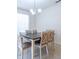 Bright dining room featuring a modern chandelier and a wooden table with six chairs at 527 Noble Ave, Davenport, FL 33837