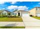 Charming single-story home with a well-manicured lawn, driveway, and attached two-car garage at 527 Noble Ave, Davenport, FL 33837