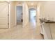 Inviting hallway with neutral walls, tile flooring, arched doorways and stylish decor at 527 Noble Ave, Davenport, FL 33837