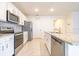 Modern kitchen featuring stainless steel appliances, granite countertops, and white cabinets at 527 Noble Ave, Davenport, FL 33837