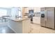 Kitchen with white cabinets, granite countertops, stainless steel appliances, and tile flooring at 527 Noble Ave, Davenport, FL 33837