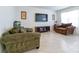 Relaxing living room with tile flooring, comfortable seating, neutral walls, and a TV at 527 Noble Ave, Davenport, FL 33837
