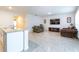 Open-concept living room featuring tile floors, comfortable seating, and views of the kitchen island at 527 Noble Ave, Davenport, FL 33837