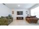 Cozy living room with comfortable seating, tile flooring, neutral walls, and a TV at 527 Noble Ave, Davenport, FL 33837