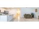 Open-concept living area featuring tile flooring, a kitchen bar, neutral walls, and lots of light at 527 Noble Ave, Davenport, FL 33837