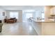 Bright living area with tile flooring, a kitchen bar, comfortable seating, neutral walls, and dining space at 527 Noble Ave, Davenport, FL 33837