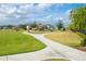 A winding walkway leads to a charming community playground and gazebo under a beautiful partly cloudy sky at 527 Noble Ave, Davenport, FL 33837
