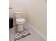 Bright bathroom featuring a standard toilet and tile floor with an accent rug at 527 Noble Ave, Davenport, FL 33837