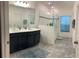 Modern bathroom with double sinks and walk-in shower at 723 Benjamin Trl, Davenport, FL 33837