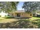 House backyard with grassy lawn and mature trees at 9650 Bay Pine Ln, Orlando, FL 32832
