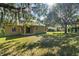 Spacious backyard with lush lawn and large shade trees at 9650 Bay Pine Ln, Orlando, FL 32832