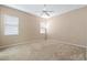 Bright bedroom with neutral walls, carpet, and two large windows at 9650 Bay Pine Ln, Orlando, FL 32832