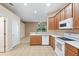 Kitchen with wood cabinets, white appliances, and tiled floor at 9650 Bay Pine Ln, Orlando, FL 32832