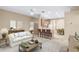 Living room features a comfy sofa and a view of the kitchen and dining area at 9650 Bay Pine Ln, Orlando, FL 32832