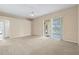 Spacious living room with carpet flooring, ceiling fan, and sliding glass doors at 9650 Bay Pine Ln, Orlando, FL 32832
