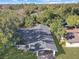 Aerial view of the home with lush landscaping, mature trees, and a carport at 1234 Lynwood Ave, Apopka, FL 32703