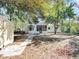Backyard with a brick pathway leading to the screen patio and shade trees at 1234 Lynwood Ave, Apopka, FL 32703