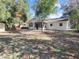 Large backyard featuring a white home, screen patio and mature shade trees at 1234 Lynwood Ave, Apopka, FL 32703