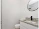 Modern bathroom featuring granite countertops, a stylish mirror, and sleek black fixtures at 1234 Lynwood Ave, Apopka, FL 32703
