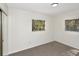 Empty bedroom features neutral carpet, a window, and a closet for storage at 1234 Lynwood Ave, Apopka, FL 32703