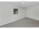 A bright bedroom with window and closet features neutral tones and minimalist design at 1234 Lynwood Ave, Apopka, FL 32703