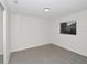 Empty bedroom features neutral carpet, a window, and a closet for storage at 1234 Lynwood Ave, Apopka, FL 32703