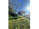 Sunny front yard with lush grass, mature trees, and a glimpse of the water at 1234 Lynwood Ave, Apopka, FL 32703