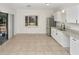 Bright kitchen features stainless steel appliances, granite countertops, and a bay window with backyard views at 1234 Lynwood Ave, Apopka, FL 32703