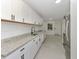 Contemporary kitchen boasts granite countertops, white cabinets, and stainless steel appliances at 1234 Lynwood Ave, Apopka, FL 32703