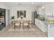 Charming kitchen with a dining area, bright white cabinets, and stainless steel refrigerator at 1234 Lynwood Ave, Apopka, FL 32703